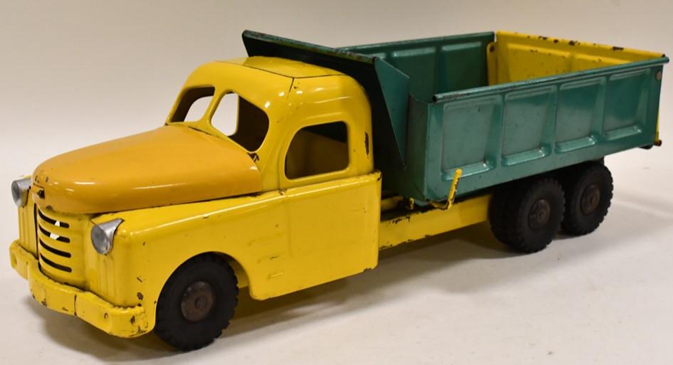 Structo Hydraulically Operated Dump Truck: Structo hydraulically operated dump truck. The hyraulic dump works. The truck has paint loss and wear from play and age. The cab has some paint touch ups. Measures approximately 20 1/2" long.