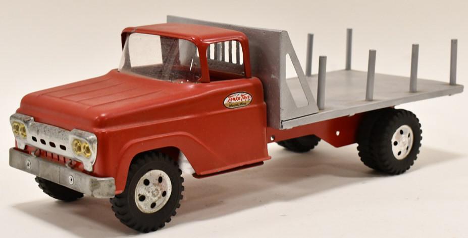 Tonka Interchangeable Bed Lumber Hauler Truck: Repainted Tonka interchangeable bed lumber hauler truck. The bed has pitting and wear from age. The truck has been repainted at sometime. Measures approximately 16" long.