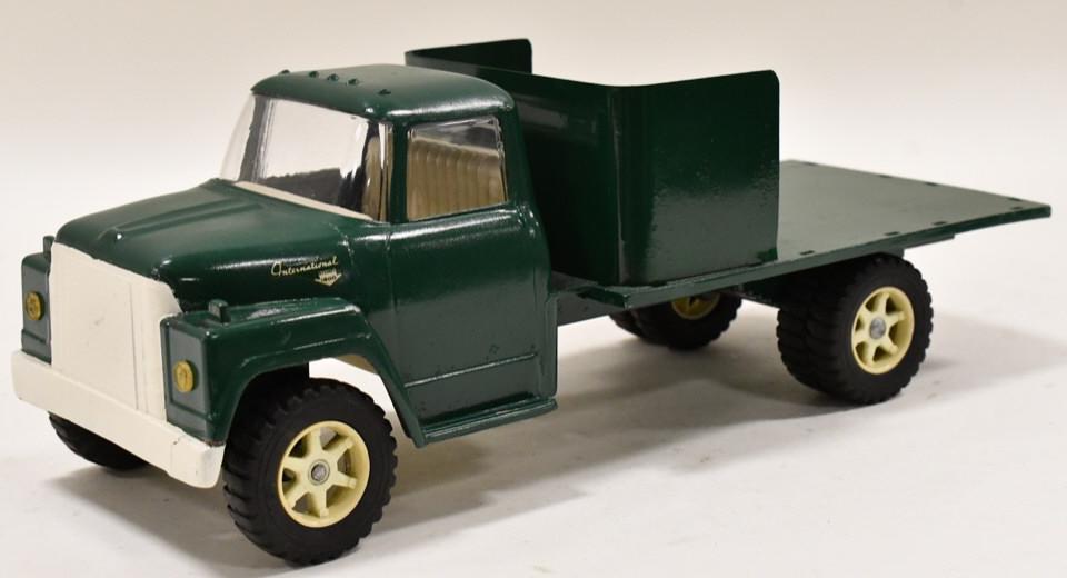 Restored Ertl IH Loadstar 1600 Stake Bed Truck: Restored Ertl IH Loadstar 1600 stake bed truck. It is missing the stakes. Good condition with a couple small paint chips and wear from storage / display. Measures approximately 1" long.