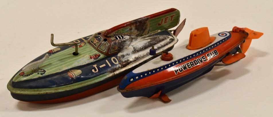 Japan Tin Litho Windup Jet Boat & Powerdive Sub: Japan tin litho windup jet boat and powerdive sub. The jet boat has heavy paint loss on the one side. The powerdive sub has some rust and paint loss from play and age. The friction motors work. Larges