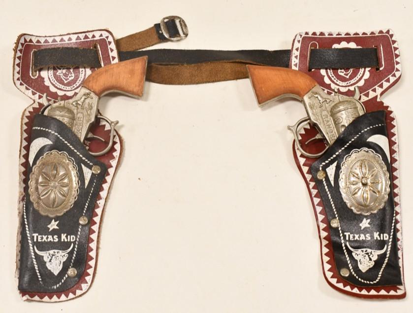 Vintage Ranger Cap Gun Set w/ Texas Kid Holster: Vintage Ranger cap gun set with Texas Kid holster. Both triggers work. The guns have some corrosion and wear from use and age. The Texas Kid holster displays well with good graphics. Each gun measures