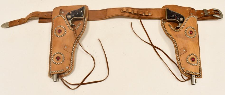 Hubley Wyatt Earp Cap Gun Set w Leather Holster: Vintage Hubley Wyatt Earp cap gun set leather holster. The cap guns have corrosion and wear from use and age. Both triggers move the hammers. The holster has some wear and tear from age. Each gun meas