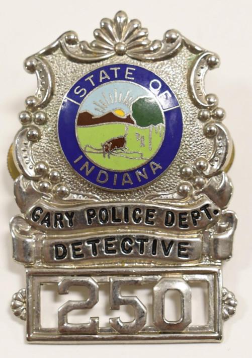 Obsolete Gary IN Police Officer Cap Badge No. 250: Vintage obsolete Gary Indiana Police Officer cap badge No.250 with enameled state seal. Overall good condition with some light surface corrosion. Has screw back. Measures approximately 2-1/2" tall by
