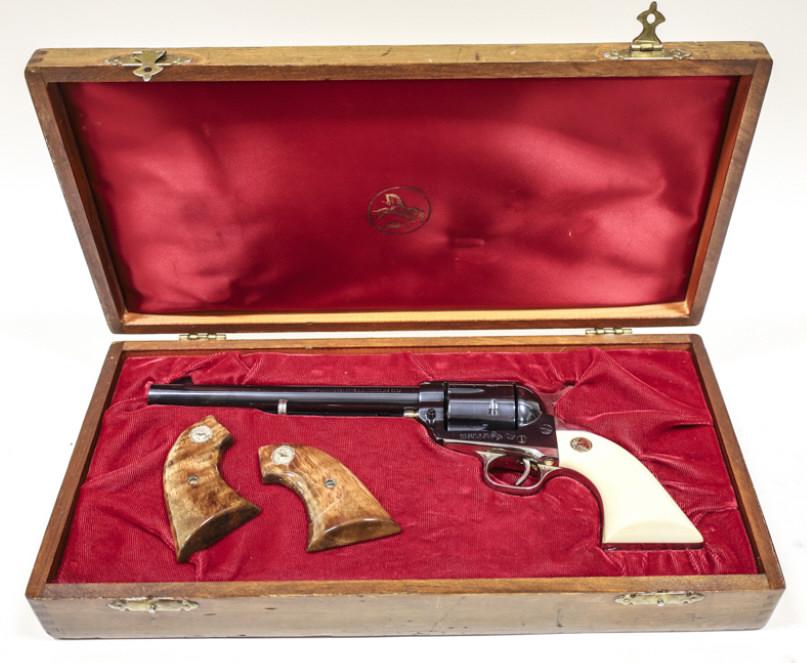 Colt Single Action Army 125th Anniversary Revolver: New in display case Colt Single Action Army 125th Anniversary Model six shot revolver in .45 caliber. The blue finish revolver is in great condition and has a 7-1/2" barrel. Comes with original wood g