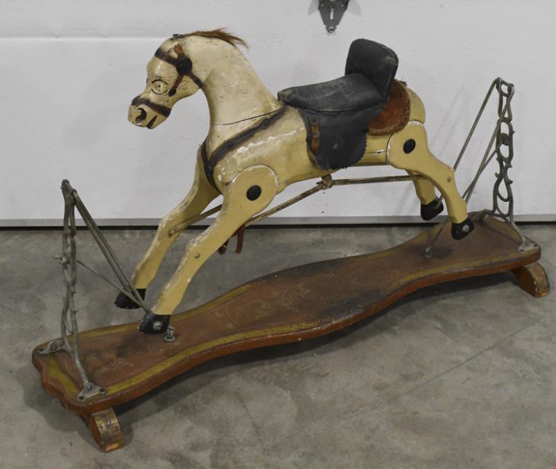Antique Victorian Wooden Glider Rocking Horse: Antique Victorian style wooden glider rocking horse. This rocking horse features glass eyes, one leather ear, and what appears to be a horse hair tail. It appears to be in fair original condition with