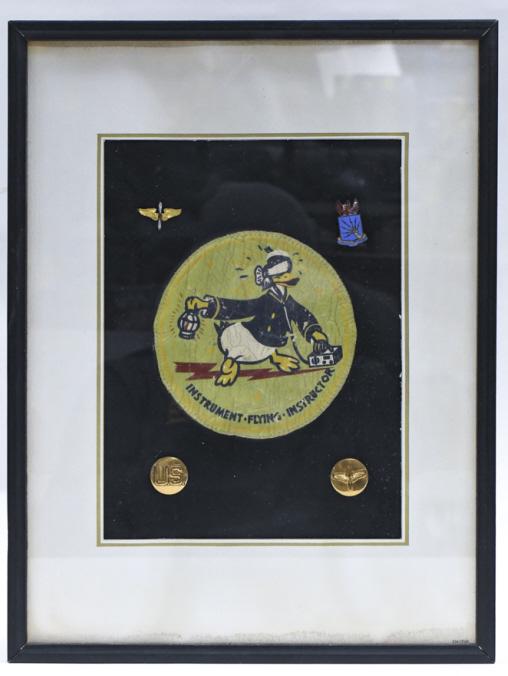 WWII Donald Duck Flying Instructor Bombers Patch: Framed WWII hand painted Donald Duck Instrument Flying Instructor bombers patch and mores. Patch is in fair condition with crack paint and wear from use and age. Framed display includes four other us