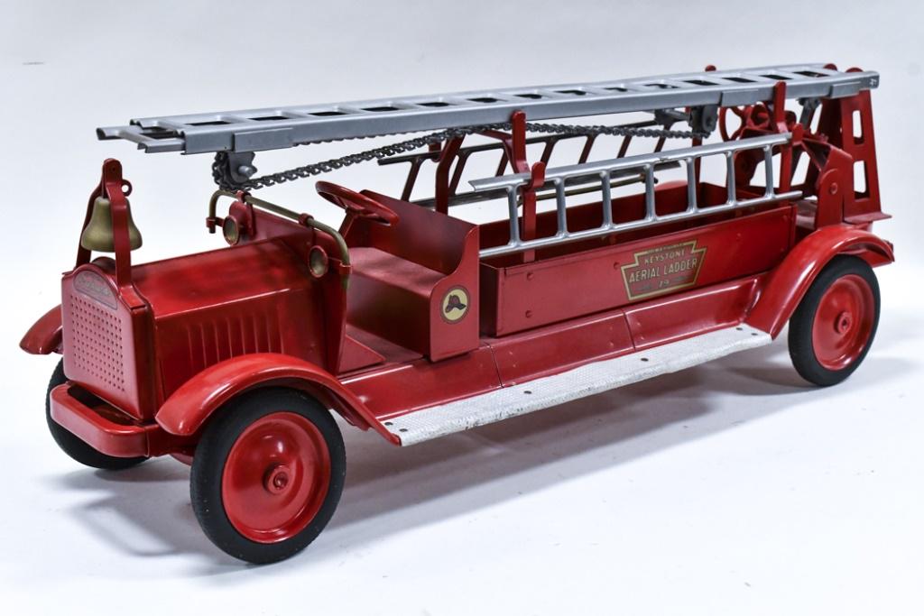 Restored Keystone Packard #79 Aerial Ladder Truck: Restored Keystone Packard #79 aerial ladder truck. Displays well with brass bell, ladders, and Keystone Hood Balloon tires. Good condition with light wear from storage and display. Measures approximat