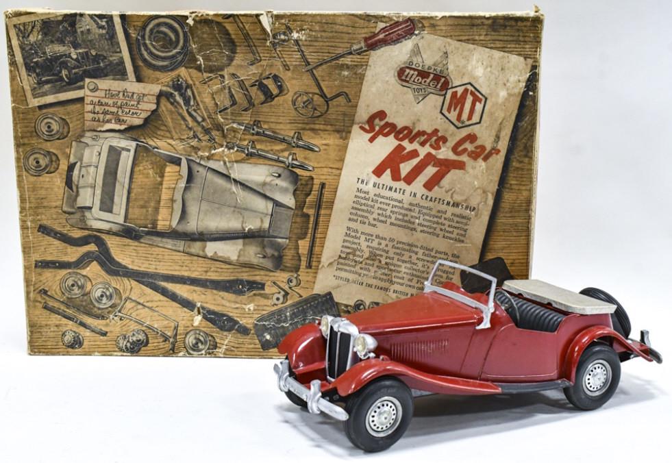 Doepke Model Toys MG Sports Car Kit With Box: Doepke Model Toys MG sports car kit with the original box. The car is put together. Displays well with headlights, operable steering wheel, and spare tire. The car does have a couple paint chips and l