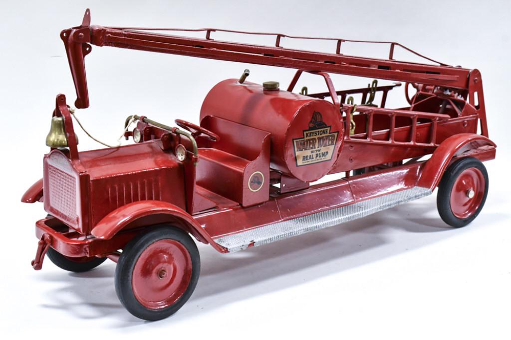 Keystone Water Tower Fire Truck With Real Pump: Restored Keystone water tower fire truck with real pump. Displays well with headlights, ladders, pump, and bell. One of the supports holding the ladders is broke. Good condition with some paint chips