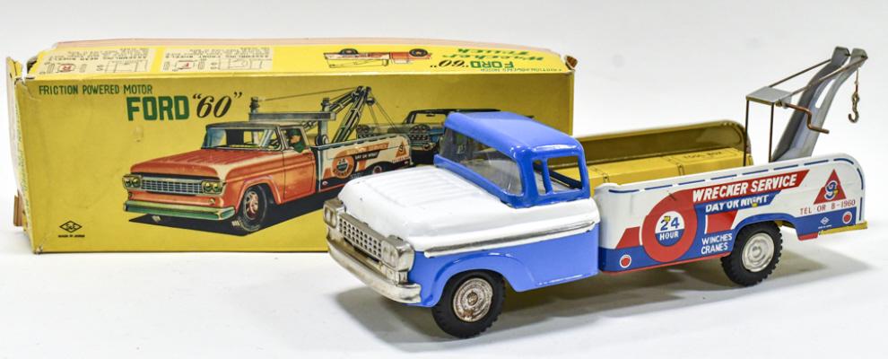 Japan Tin Friction Ford Wrecker Truck w/ Box: Japan tin litho friction Ford "60" wrecker truck with the original box. The friction appears to work. The box has some wear and tear from age and display. The truck has some scratches and light wear f