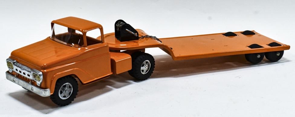 Restored Tonka Truck With Lowboy Trailer: Restored Tonka truck with lowboy trailer. Displays well painted in State Hi-Way Dept orange. The truck is in good condition with some scuffs and light wear from storage and display. Measures approxima