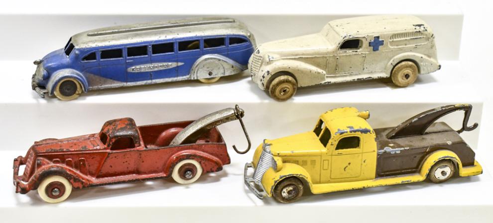 Lot Of Tootsietoy, Hubley, & Barclay Toys: Lot includes a Tootsietoy Greyhound bus and tow truck, Hubley cast iron tow truck, and Barclay ambulance. All have paint loss and wear from play and age. Largest measures approximately 5-3/4" long.