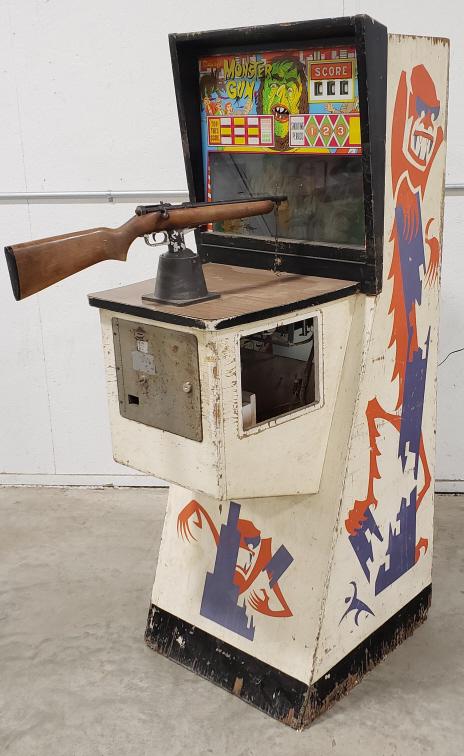 Midway's Monsters Gun Coin Op Shooting Gallery: Vintage coin operated 10 cent Midway's Mosters Gun arcade shooting gallery game. Appears to be in fair cosmetic condition with paint loss and wear from use and age. The side access door is missing and