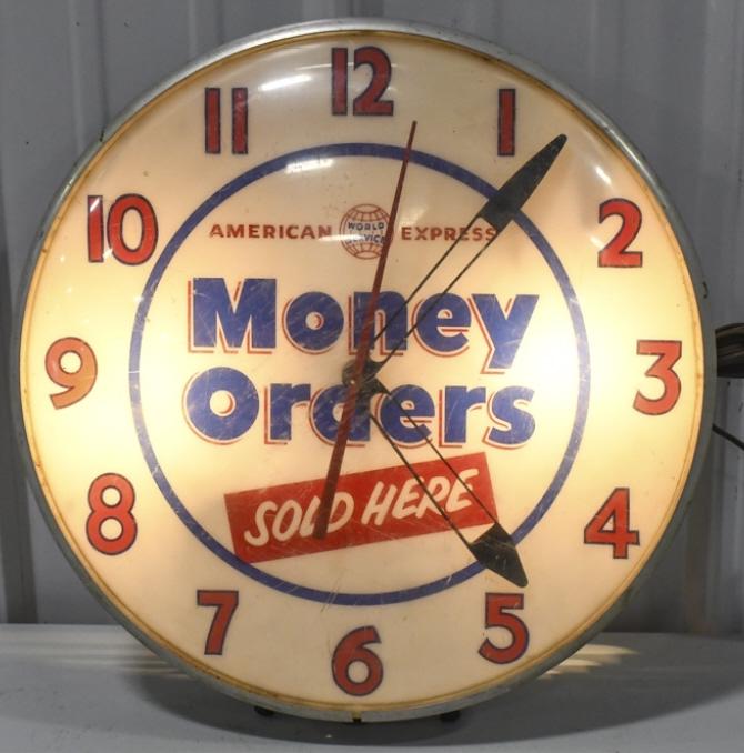 Vintage American Express Lighted Advertising Clock: Vintage American Express Money Orders lighted advertising clock by The Ohio Advertising Display Co. Clock is in good working condition with scratches on plastic outer bubble, some paint loss and surfa