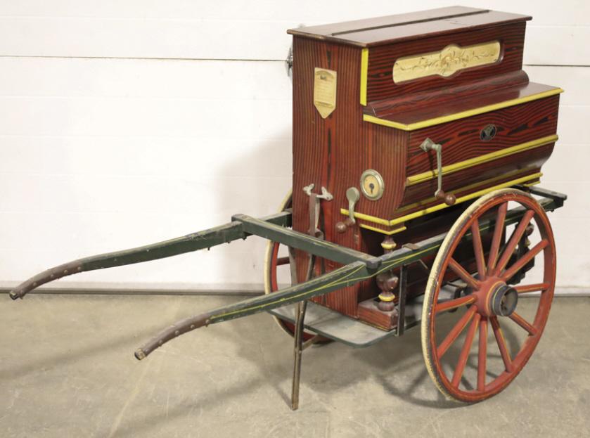 Vicente Llinares Hurdy Gurdy Windup Organ On Cart: Vicente Llinares Hurdy Gurdy windup organ with cart. The organ works, but needs tuned. It comes with a child's buckboard-style wagon. Good condition with scratches and wear from use and age. Measures 