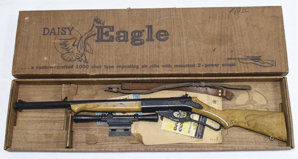 Vintage Daisy Eagle No.98 Air Rifle In Box: Vintage Daisy model no.98 Eagle air Rifle in original box, with scope, strap, and paperwork. Appears to be in overall fair condition with wear from use and age. The plastic forearm has a damaged mount