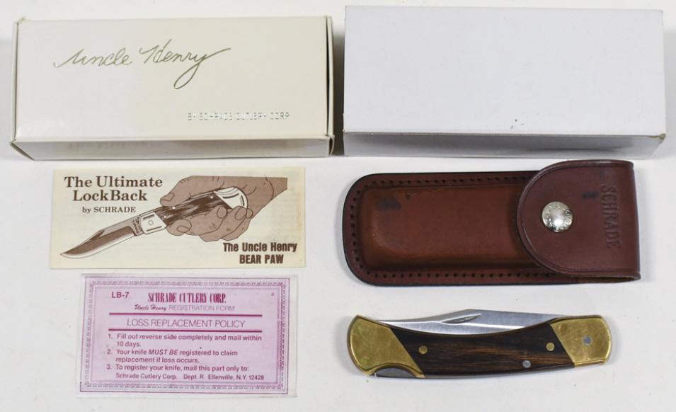 Vintage Schrade Uncle Henry LB-7 Folding Knife: Vintage Schrade Uncle Henry model no. LB-7 folding knife in original box with paperwork and leather sheath. Knife appears to be in good condition with some oxidation on brass handle and wear from use,