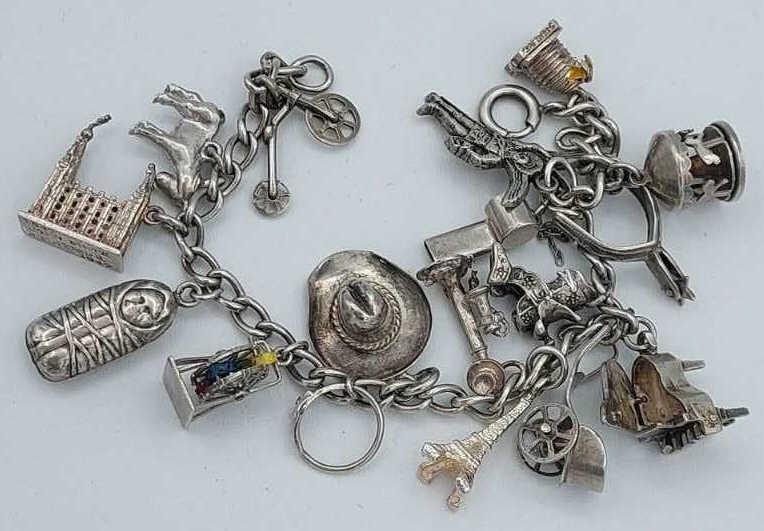 Sterling Silver Charm Bracelet With Charms: Sterling silver charm bracelet with charms. Total Weight 36.7 grams.