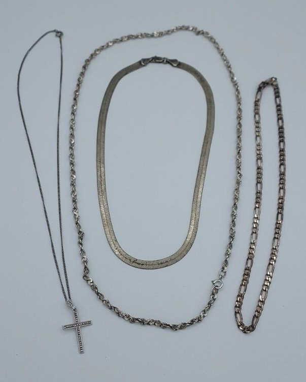 Set of four (4) Sterling Silver Necklaces: Set of four sterling silver necklaces, one with a marcasite cross pendant. Total weight 54.6 grams.