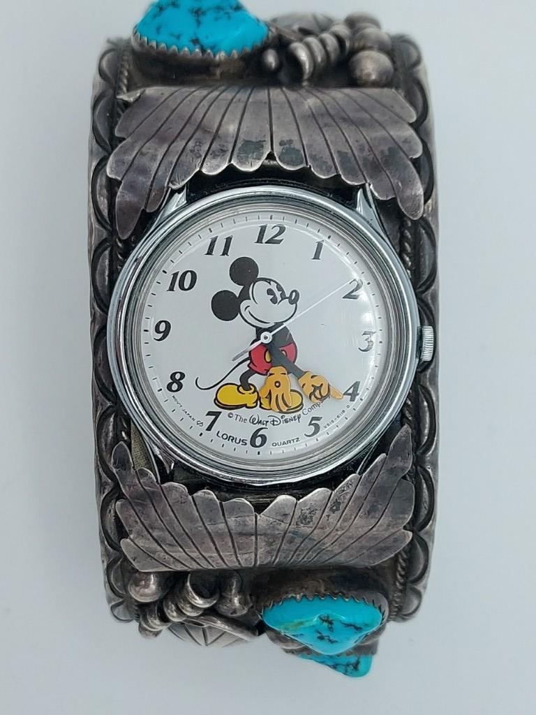 Sterling & Turquoise Watch Cuff & Disney Watch: Sterling silver and turquoise watch cuff marked RB, with The Walt Disney Company Mickey Mouse Lorus Quartz watch face. Width 3", Total weight 77.3 grams.