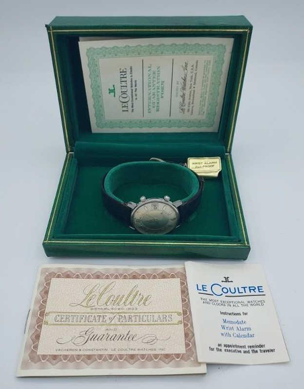 Men's Jaeger Le Coultre Memodate Wristwatch: Vintage stainless steel Le Coultre Memodate wristwatch. Alarm and calendar watch. Leather strap with steel Le Coultre pin buckle. Comes witth original box, instruction manuel and certificate.
