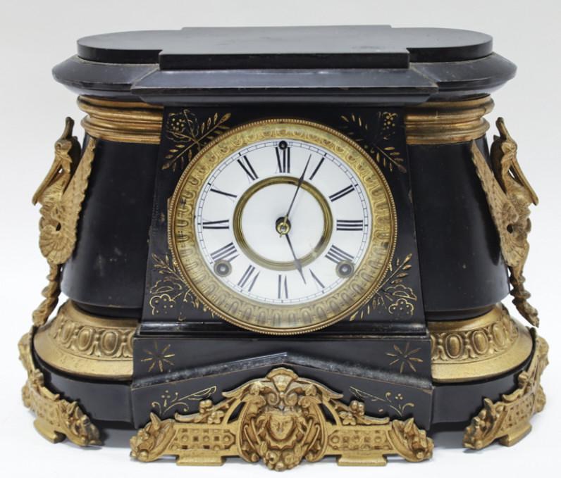 Ansonia "Pompei" Metal Mantel Clock: Ansonia "Pompei" Metal Mantel Clock with Phoenix mounts. Some chipping. Clock comes with pendulum and key. Working condition. Measures 14.5" across, 11" tall, 7" deep.