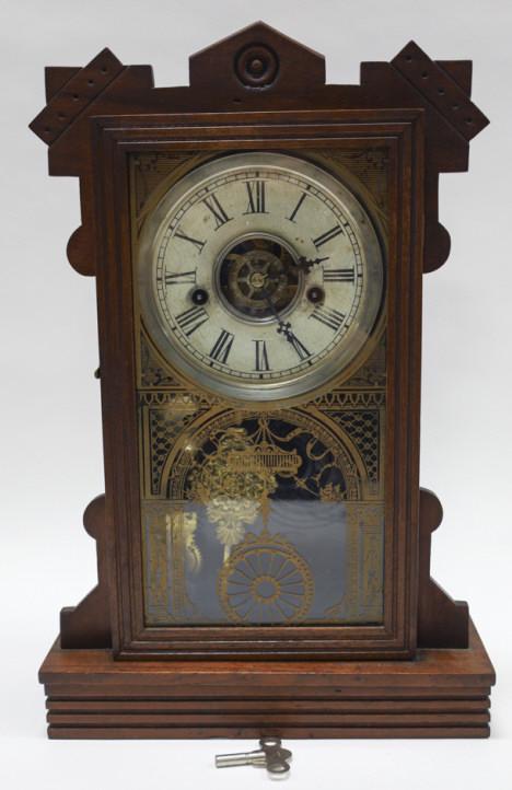 Antique Waterbury Clock Co. Mantel Clock: Antique Waterbury Clock Co Mantel Clock. Clock comes with pendulum and key. Measures 11.25" across, 17.25" tall, 4" deep.