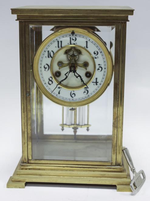 Antique Waterbury Crystal Regulator Clock: Antique Waterbury Crystal regulator clock with brocot escapement. Porceain face and faux lead pendulum. Made in USA. Working condition. Measures 7.5" across, 10.25" tall, 6.25" deep.