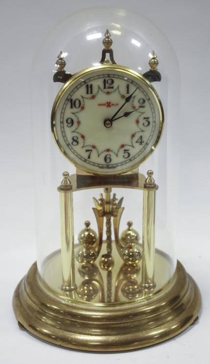 Vintage Howard Miller Anniversary Mantel Clock: Vintage Howard Miller anniversary mantel clock. Plastic dome. Made in Germany. Measures 7 across, 12" tall, 7" deep.