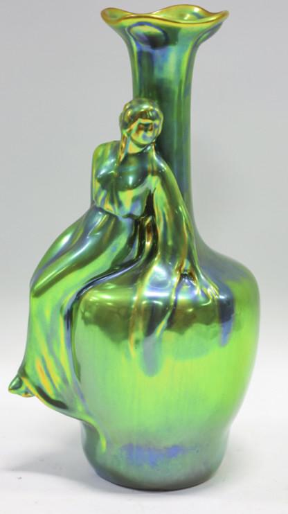 Vintage Zsolnay Green Iddidescent Figural Vase: Vintage Zsolnay Hungary irridescent green figural vase. Vase is in good condition with little wear. Vase marked on base. Features a lady seated on the edge on vase. Measures 4.75" across, 9.5" tall