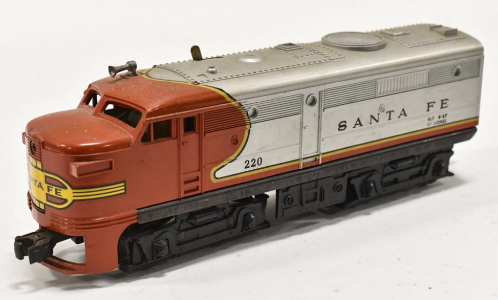 Lionel Santa Fe #220 Powered Diesel Locomotive: Lionel Santa Fe #220 powered diesel locomotive. Good condition with wear from use and age.