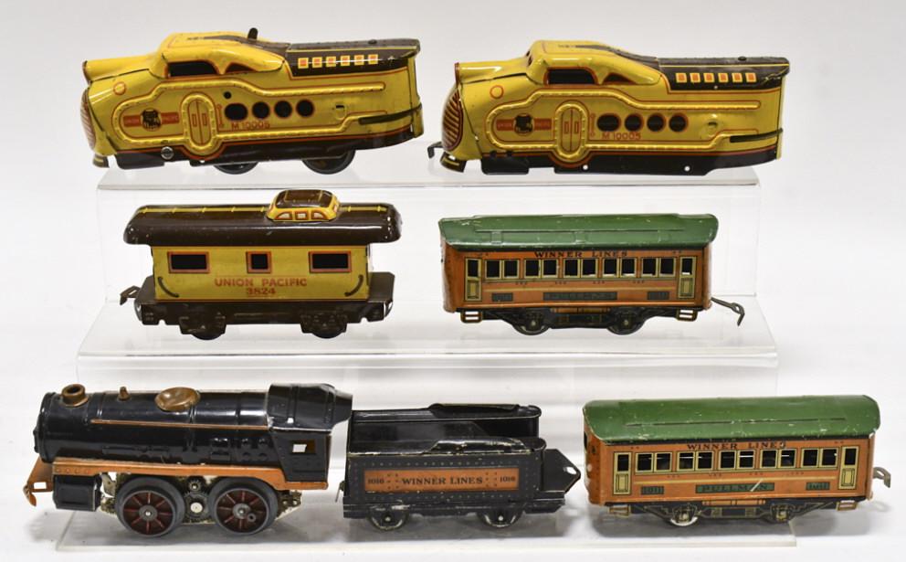 Marx U.P. Train Set & Winner Lines Train Set: Marx tinplate Union Pacific train set. The non-powered engine is missing the wheels. Also includes a Winner Toy Corp train set including an engine, tender, and (2) passenger cars. The cars have scratc