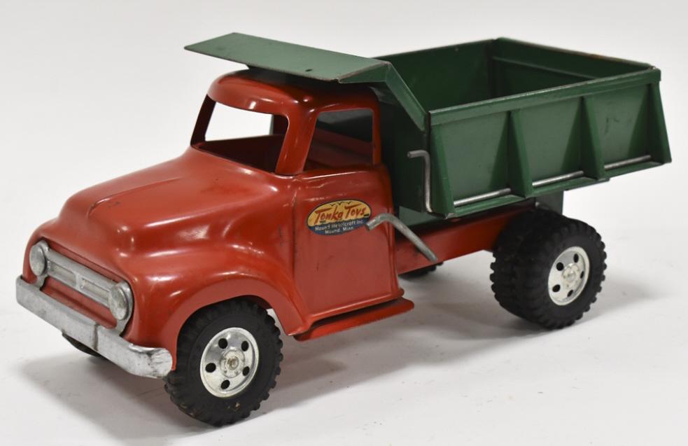Original Tonka Round Fender Dump Truck: Original Tonka round fender dump truck. Good condition with some paint loss and wear from play and age. The bed dumps. Measures approximately 13-1/2" long.