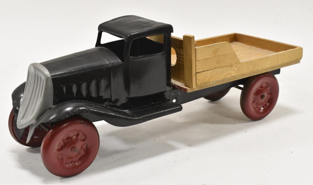 Custom Turner Toys Truck With Wood Bed: Custom Turner Toys truck with wood bed. The truck has been repainted at sometime. It has scuffs and wear from storage and display. Measures approximately 16" long.