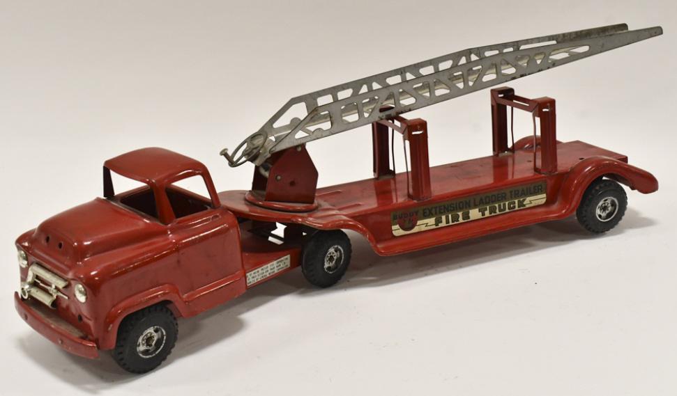 Original Buddy L Extension Ladder Fire Truck: Original Buddy L #550 fire truck with extension ladder trailer. The truck has paint loss and wear from play and age. The truck has damage to the grill. Measures approximately 27" long.