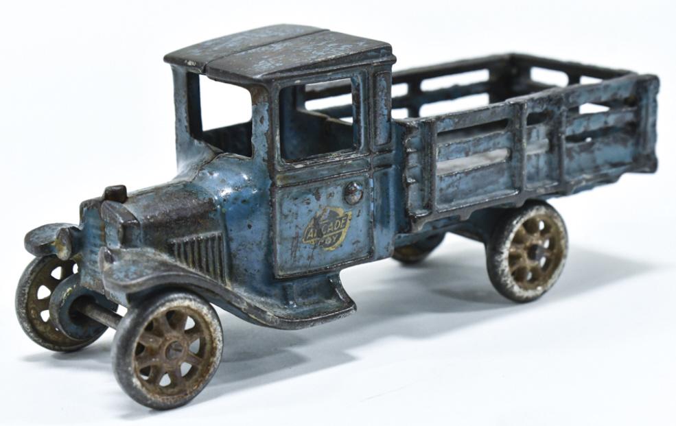 Arcade Cast Iron Stakebed Truck No. 203: Cast iron Arcade stakebed truck no. 203. Displays well with most of the original Arcade decal. The truck has paint loss and wear from play and age. Measures approximately 7" long.