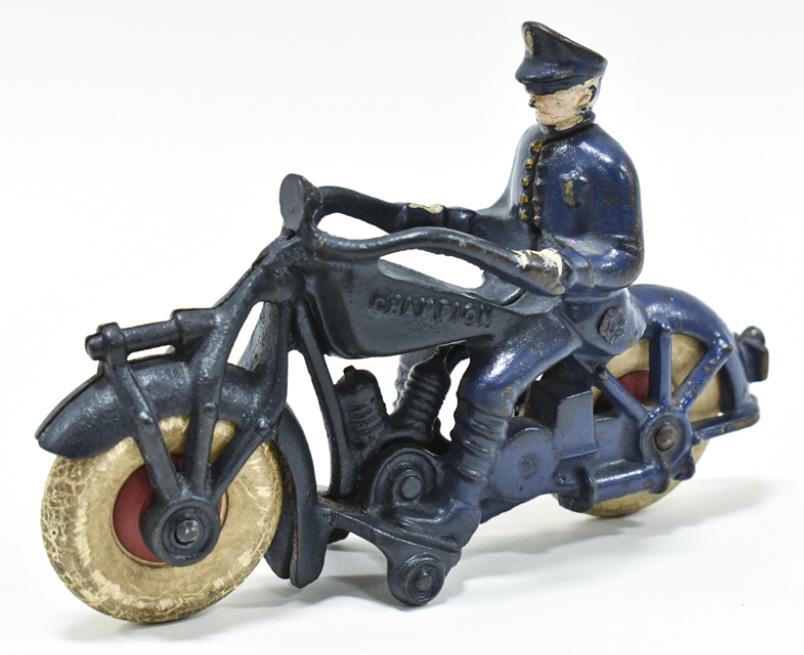 Hubley Cast Iron Champion Police Motorcycle: Cast iron Hubley Champion police motorcycle. Displays well with "Champion" embossed on both sides of the tank. The tires have cracking and wear from age and play. Measures approximately 7" long.