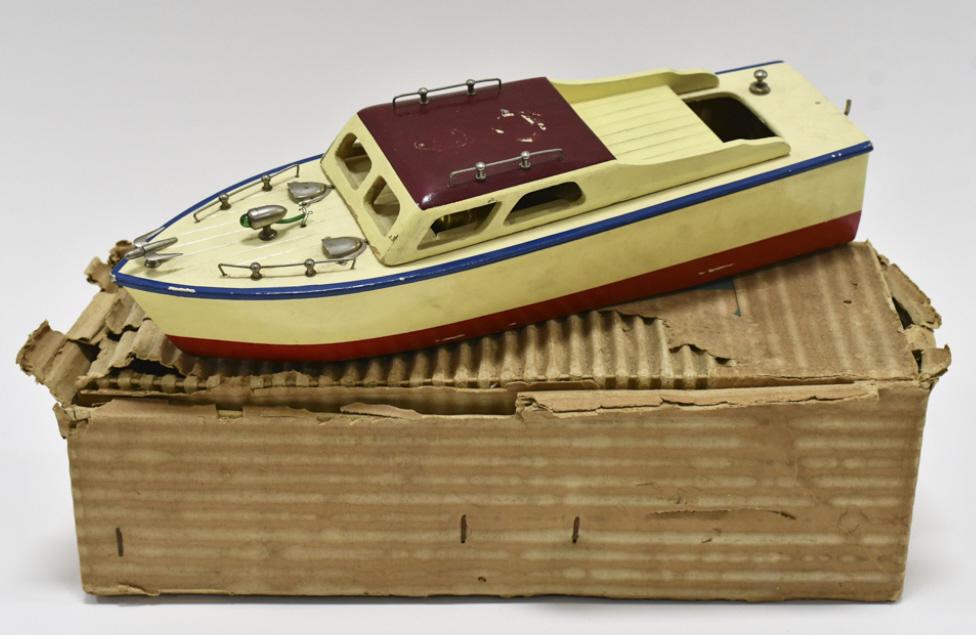 Japan Battery Op. Wood Boat w/ Box: Japan battery operated wood boat with the original box. The box is missing the label and has heavy wear. The boat has some paint loss and wear from use and age. Measures approximately 12" long.