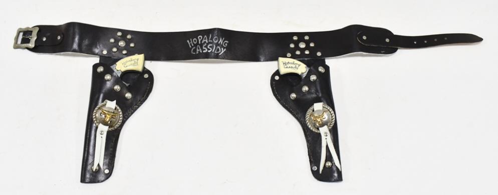 Wyandotte Hopalong Cassidy Cap Gun Set w/ Holster: Wyandotte Hopalong Cassidy single shot cap gun set with Hopalong Cassidy leather holster. The cap guns have some corrosion and wear from use and age. The holster has some cracking and wear from age. E