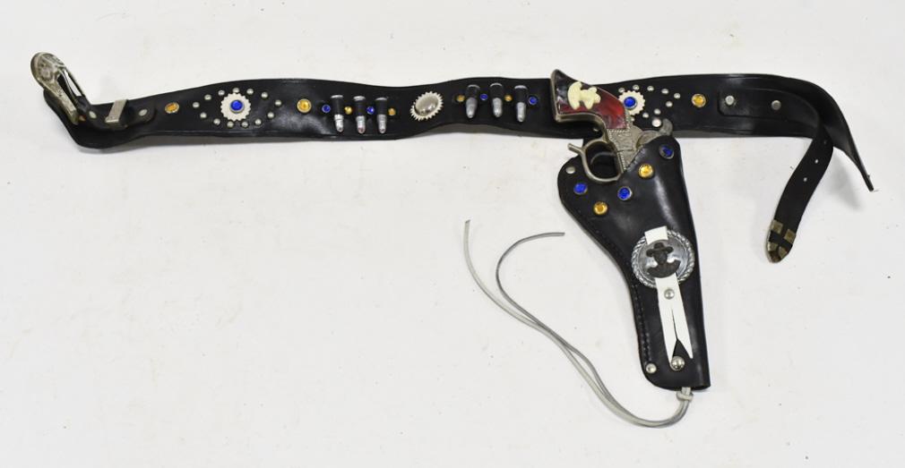 Geo Schmidt Buck'N Bronc Cap Gun w/ Holster: Geo. Schmidt Buck'N Bronc cap gun with Hopalong Cassidy leather holster. The cap gun has some corrosion and wear from use and age. The holster has some cracking and wear from age. The gun measures app