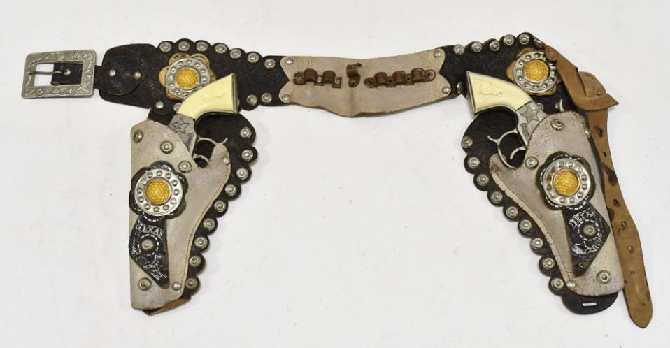Leslie Henry Texas Ranger Cap Gun Set w/ Holster: Leslie Henry Texas Ranger cap gun set with Texas Ranger leather holster. The cap guns have some corrosion and wear from use and age. The holster has some cracking and wear from age. Each gun measures 