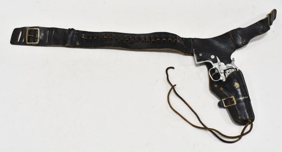 Nichols Stallion 32 Cap Gun w/ Leather Holster: Nichols Stallion 32 cap gun with Nichols Notch-It 32 leather holster. The cap gun has some corrosion and wear from use and age. The holster has some cracking and wear from age The gun measures approxi