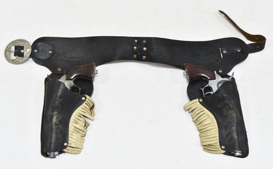 Wyandotte Red Ranger Cap Gun Set w/ Zorro Holster: Wyandotte Red Ranger cap gun set with Zorro leather holster. The cap guns have some corrosion and wear from use and age. The holster has some cracking and wear from age. Each gun measures approximatel
