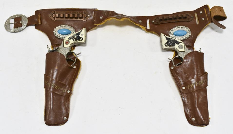 Hubley Texan Cap Gun Set w/ Leather Holster: Hubley Texan cap gun set with Maverick leather holster. The cap guns have some corrosion and wear from use and age. The holster has some cracking and wear from age. Each gun measures approximately 9-1