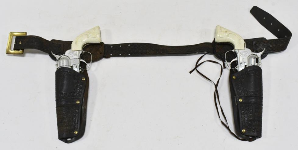 Mattel Fanner 50 Cap Gun Set w/ Leather Holster: Mattel Fanner 50 cap gun set with Cowboy In Africa leather holster. The cap guns have some corrosion and wear from use and age. The holster has some cracking and wear from age. Each gun measures appro