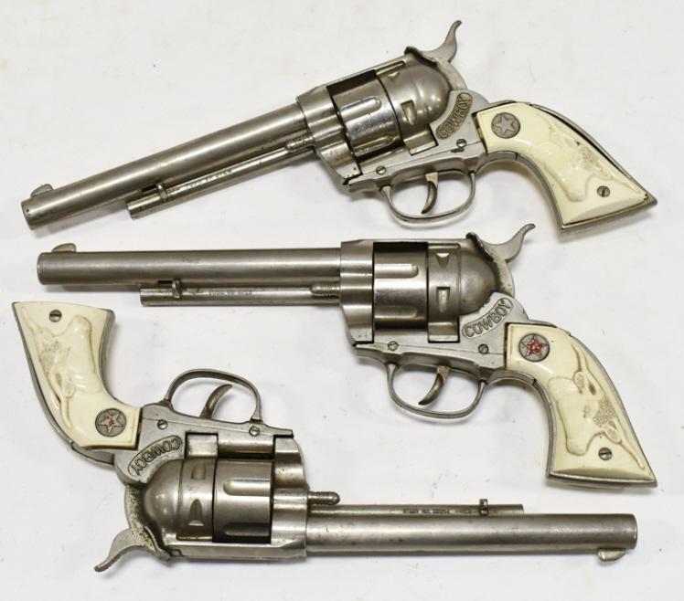 (3) Hubley Cowboy Cap Gun Pistols: (3) Hubley Cowboy cap gun pistols. Good condition with some wear from use and age. Each gun measures approximately 11-1/2" long.