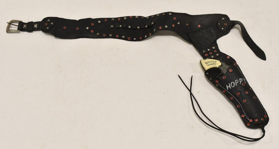 Wyandotte Hopalong Cassidy Cap Gun w/ Holster: Wyandotte Hopalong Cassidy cap gun with single leather holster. The cap gun has some wear from use and age. The holster has some cracking from age. The gun measures approximately 7-1/2" long.