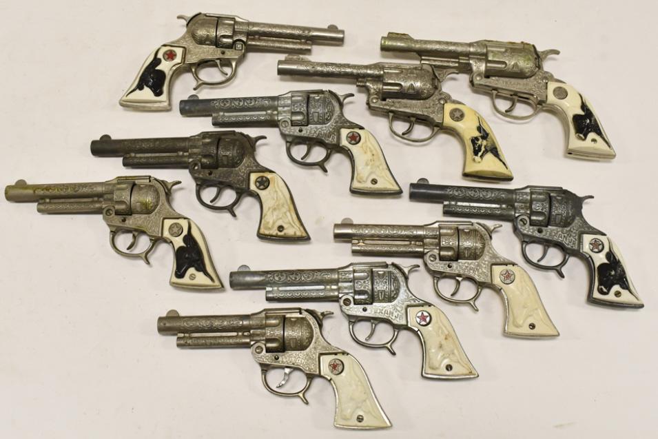 (10) Hubley Texan Jr. Cap Guns: (10) Hubley cast iron Texan Jr. cap guns. The guns have some corrosion and wear from use and age. Largest gun measures approximately 9" long.