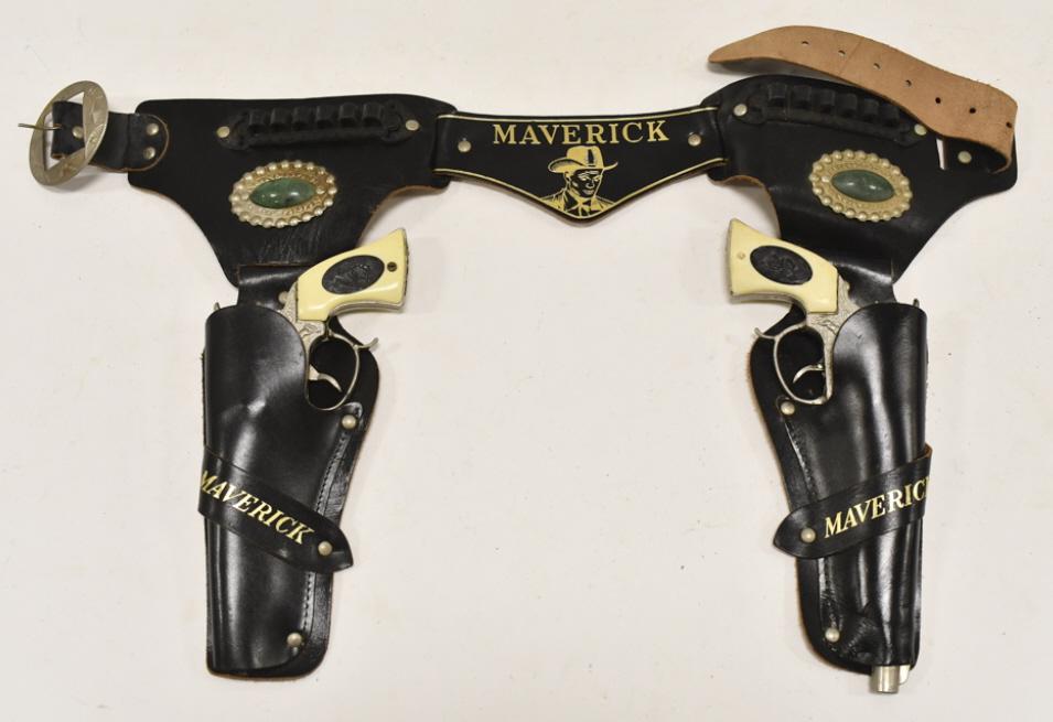 Leslie Henry Maverick Cap Gun Set w/ Holster: Leslie Henry Maverick cap gun set with leather holster. The guns have some corrosion and wear from use and age. The holster has some cracking. Each gun measures approximately 8-1/2" long.