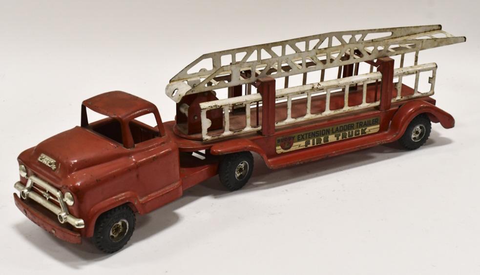 Original Buddy L Extension Ladder Fire Truck: Original Buddy L extension ladder fire truck. The truck has some paint loss and wear from play and age. Includes aerial ladder and two extension ladders. Measures approximately 27" long.